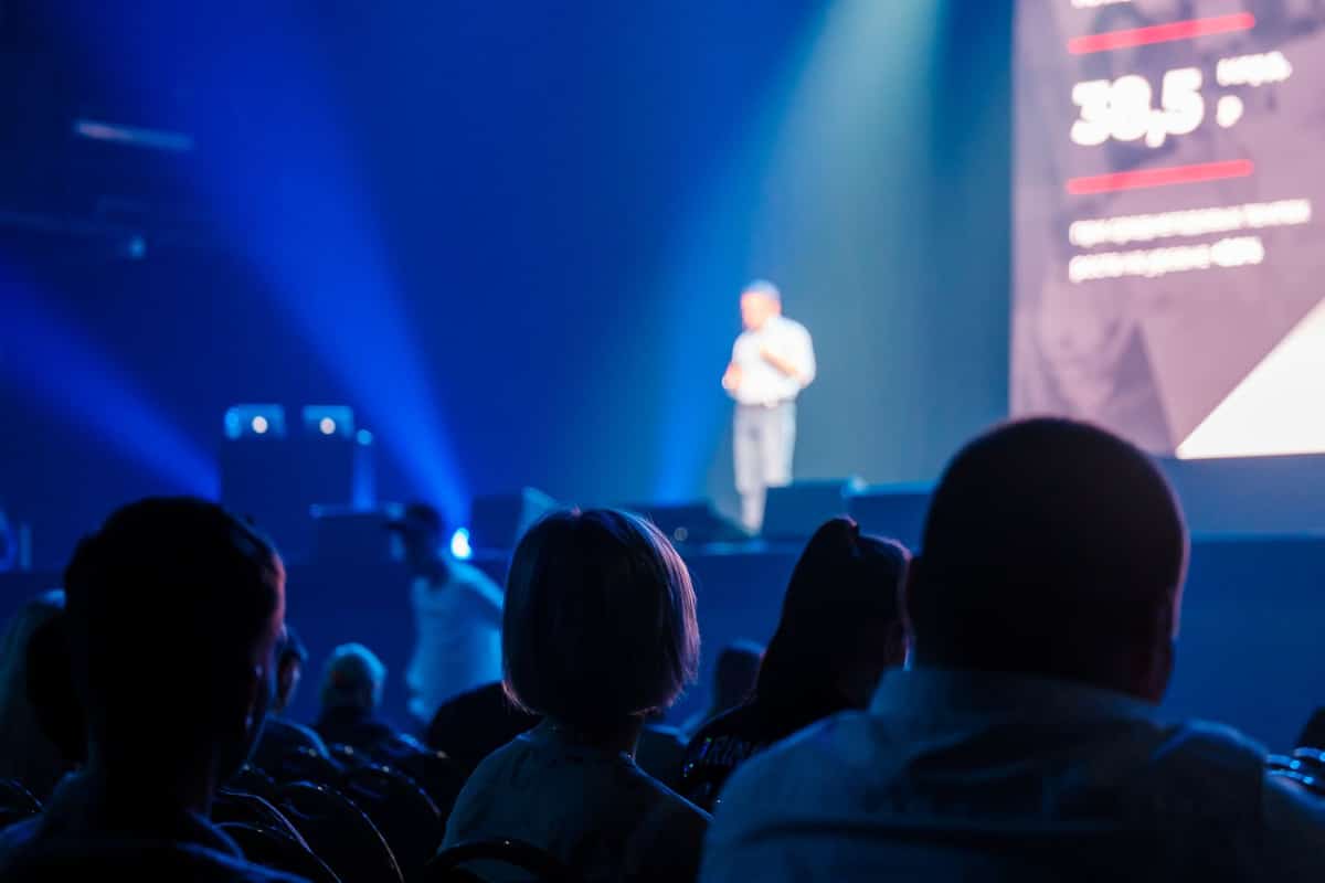 An audience listening to a speaker