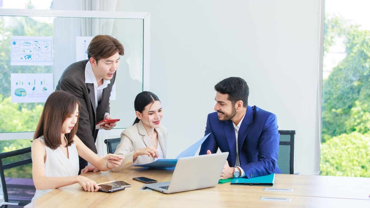A product team working through ideas on laptops