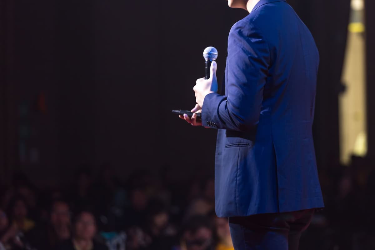 A leader speaking into a microphone