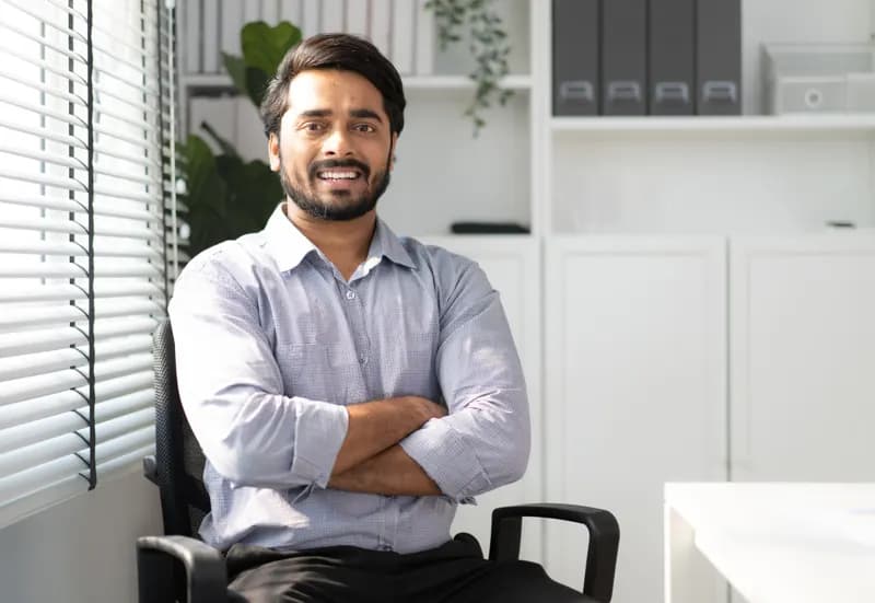 A senior leader in his office, arms folded