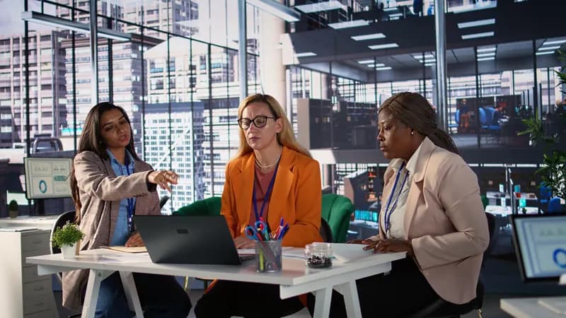 Women leaders in discussion around an office table