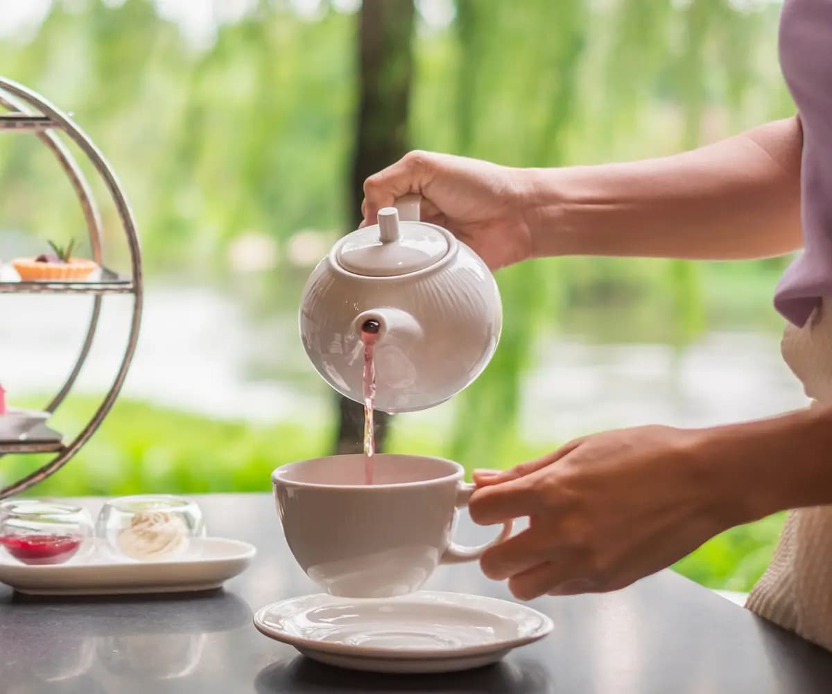 Tea being poured at an afternoon tea service