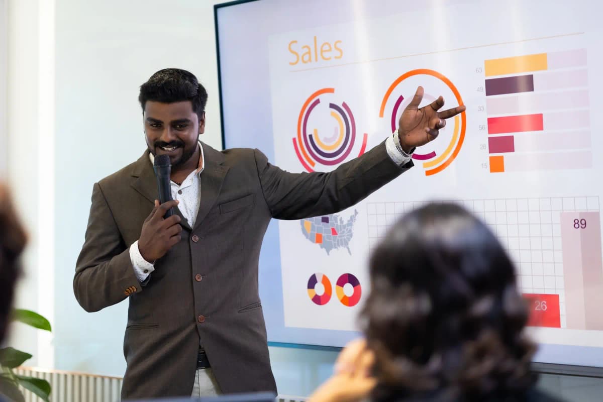 A leader presenting a report to colleagues on a screen