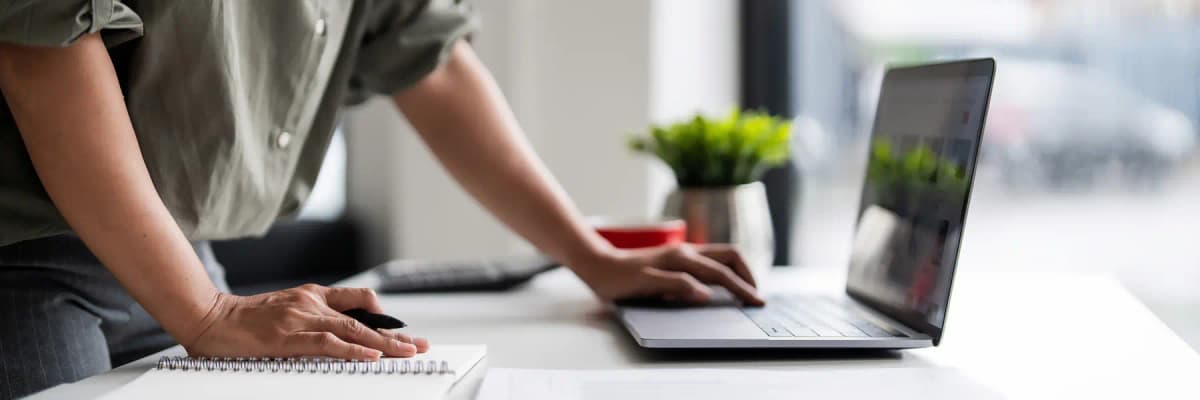 A professional researching business data on a laptop