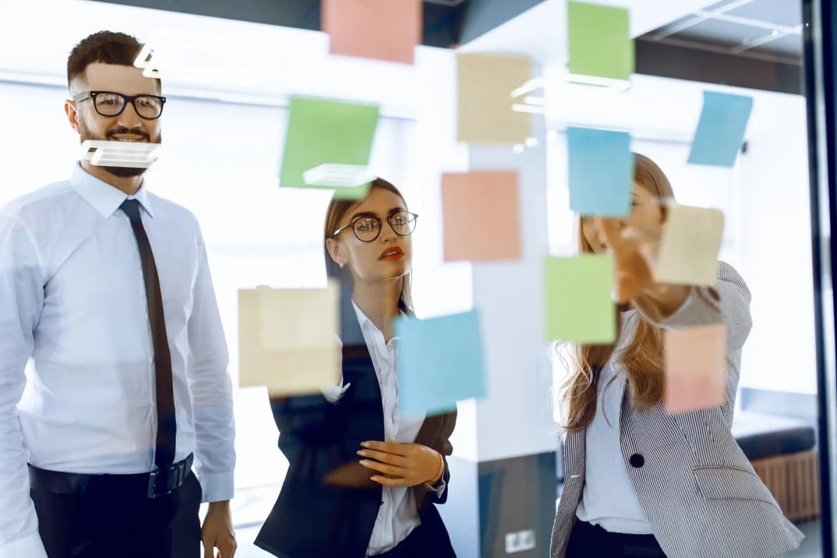 A leadership team around a whiteboard in a strategy session